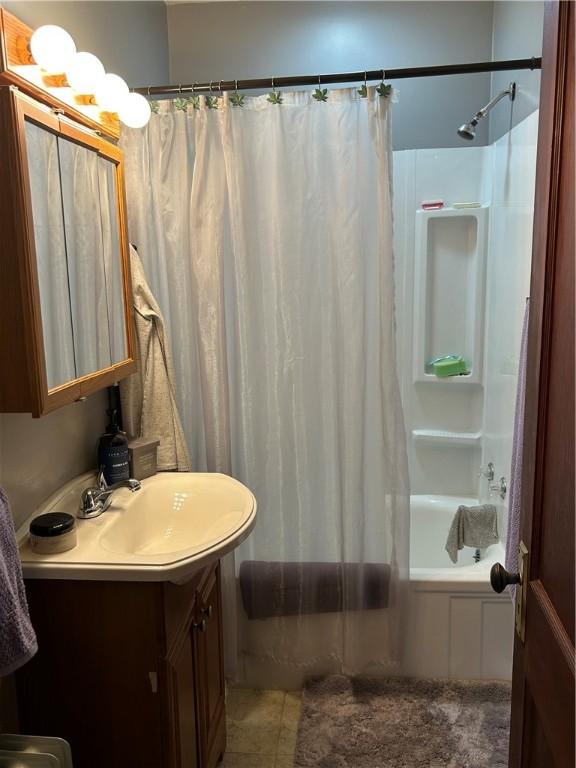 bathroom with vanity and shower / bath combination with curtain