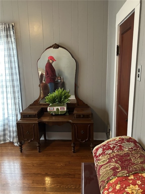 room details featuring wood-type flooring and wooden walls