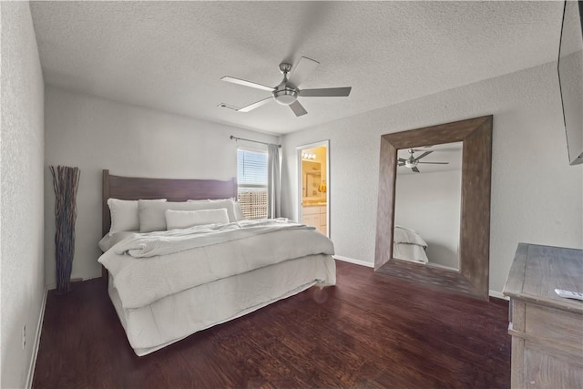 bedroom featuring dark wood-type flooring, ceiling fan, connected bathroom, and a textured ceiling