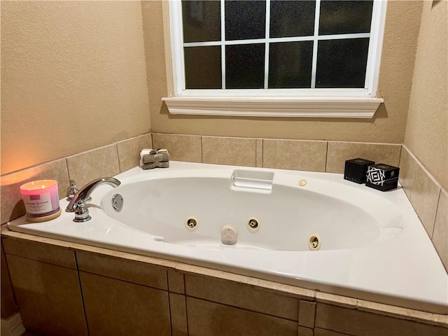 bathroom featuring tiled tub