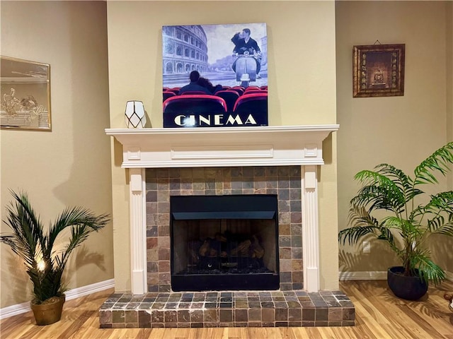 room details featuring a brick fireplace and hardwood / wood-style floors