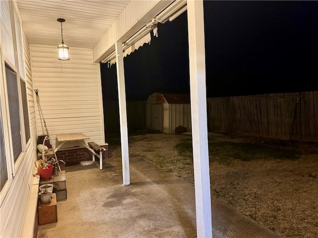 view of patio featuring a storage unit