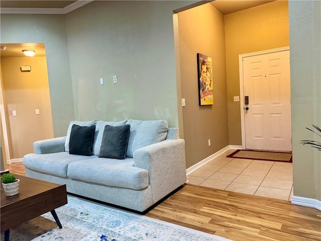 living room featuring light hardwood / wood-style floors and crown molding