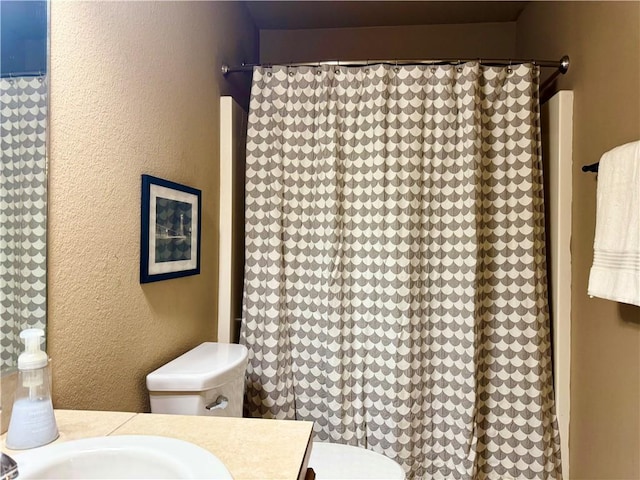 bathroom featuring toilet and vanity