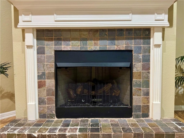 interior details with a tile fireplace