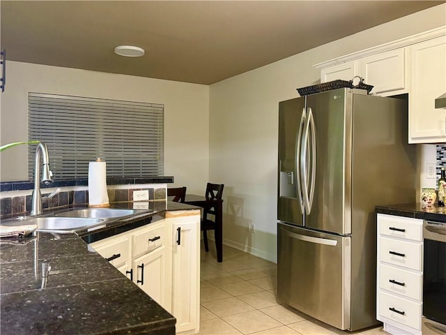 kitchen featuring stainless steel refrigerator with ice dispenser, light tile patterned floors, white cabinetry, and sink