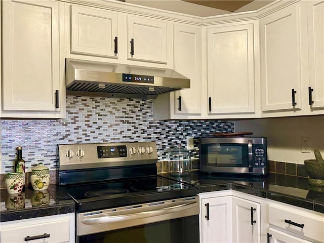 kitchen with tasteful backsplash, white cabinets, wall chimney exhaust hood, and stainless steel appliances