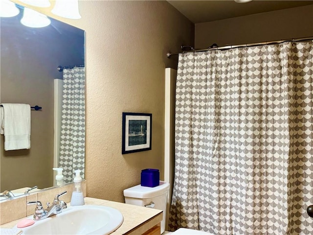 bathroom featuring toilet and vanity