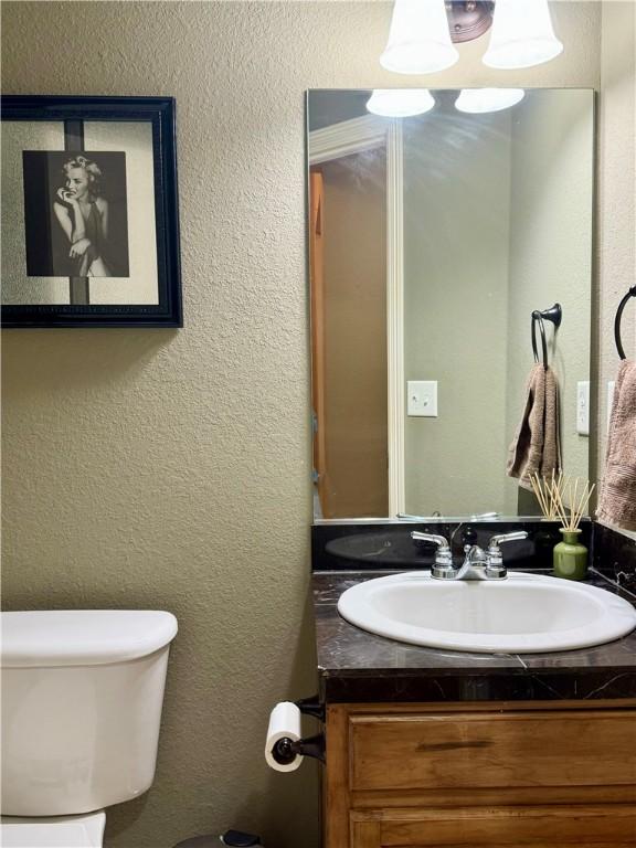 bathroom with toilet and vanity