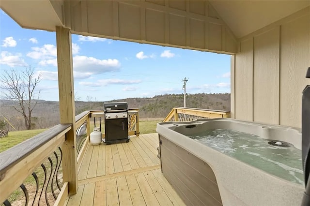 deck with a grill and a hot tub