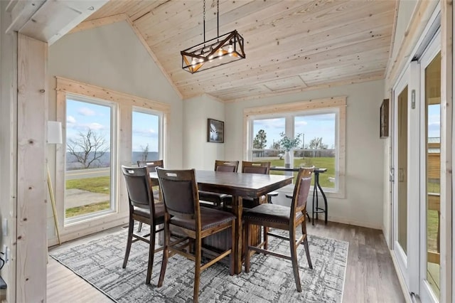 dining space featuring wooden ceiling, a wealth of natural light, vaulted ceiling, and light wood-type flooring