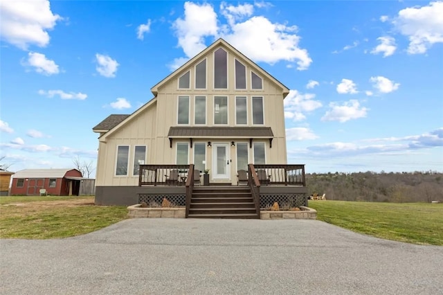 view of front facade with a deck and a front yard