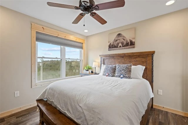 bedroom with ceiling fan and dark hardwood / wood-style flooring