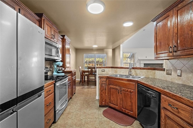 kitchen with appliances with stainless steel finishes, backsplash, and sink