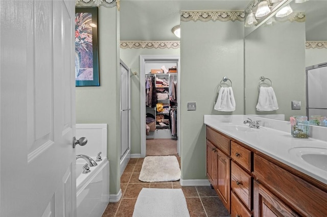 bathroom with plus walk in shower, vanity, and tile patterned flooring