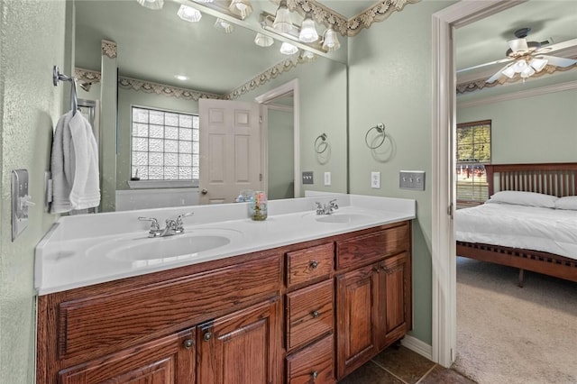 bathroom with ceiling fan, plenty of natural light, vanity, and tile patterned flooring