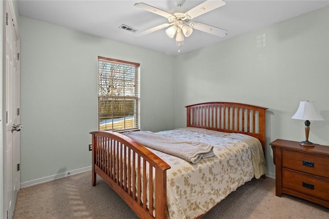 bedroom with ceiling fan and light carpet