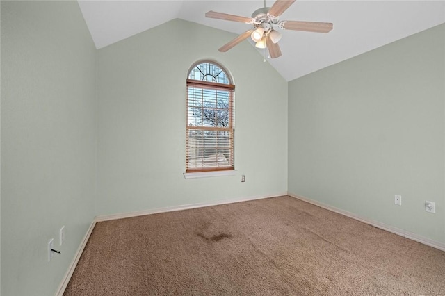 carpeted empty room featuring ceiling fan and vaulted ceiling