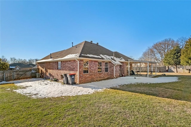 rear view of property with a lawn