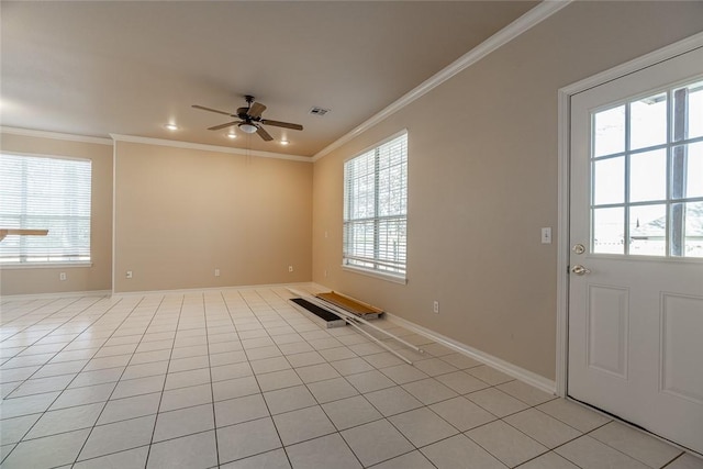 tiled spare room featuring ceiling fan, ornamental molding, and plenty of natural light