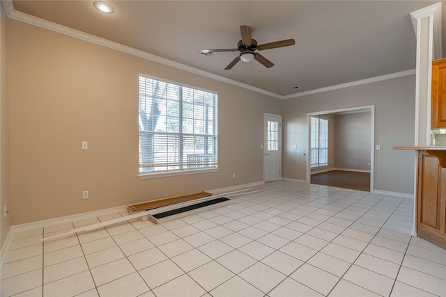 empty room featuring ceiling fan, light tile patterned floors, and ornamental molding