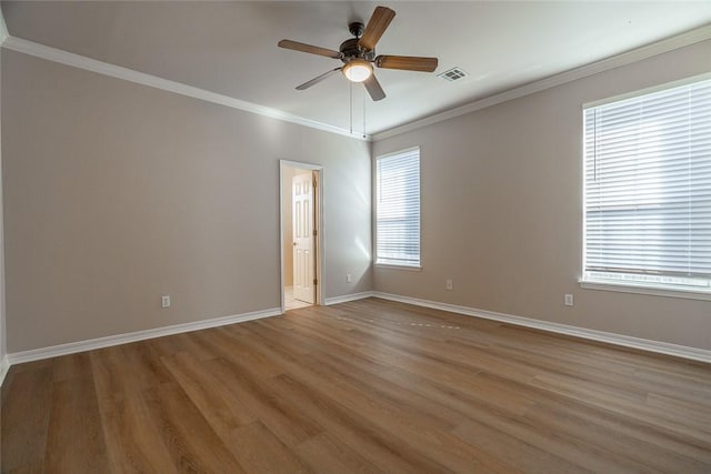 spare room featuring ceiling fan, light wood-type flooring, and crown molding