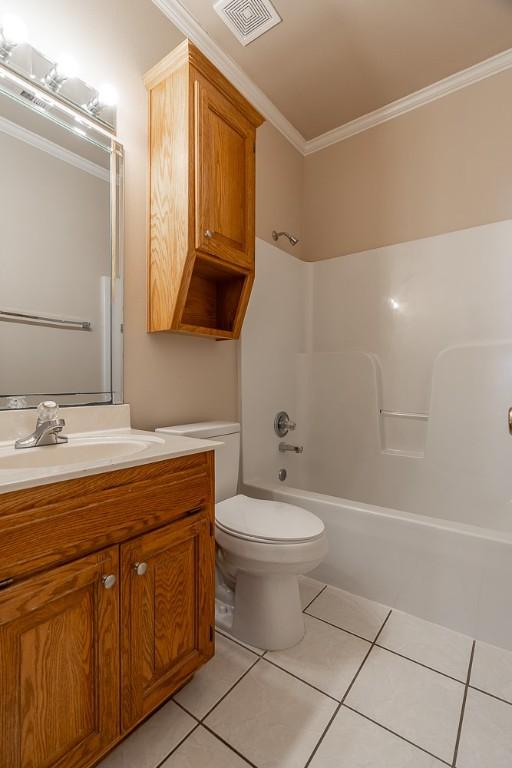 full bathroom with toilet, vanity, tile patterned flooring, crown molding, and bathing tub / shower combination