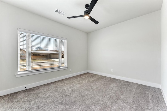 empty room featuring visible vents, baseboards, carpet, and a ceiling fan