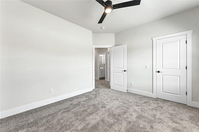 unfurnished bedroom featuring carpet flooring, baseboards, and ceiling fan