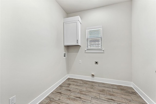 laundry room with baseboards, cabinet space, hookup for an electric dryer, and washer hookup