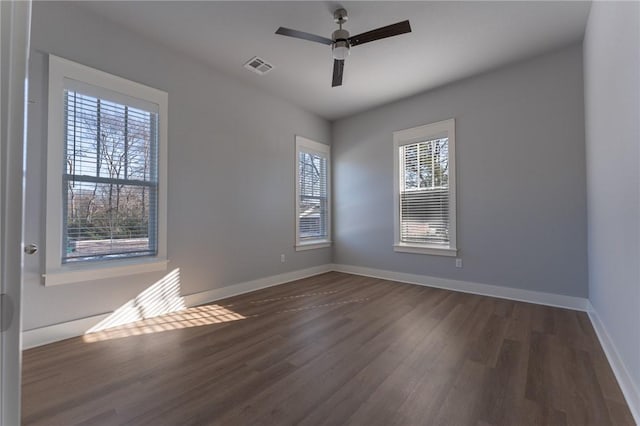 spare room featuring ceiling fan and dark wood-type flooring