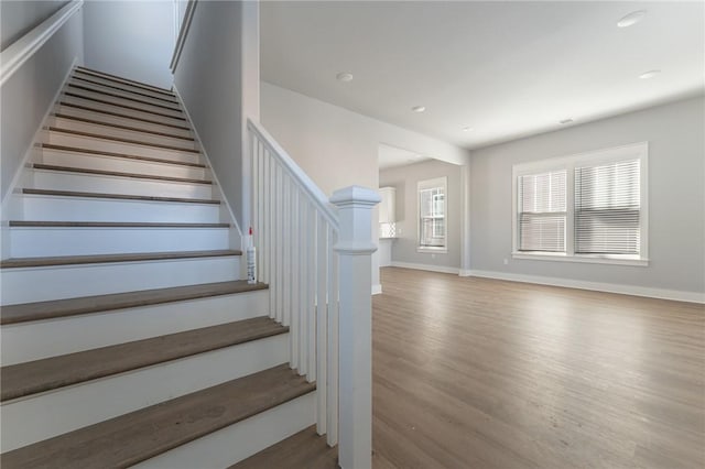 staircase with hardwood / wood-style flooring