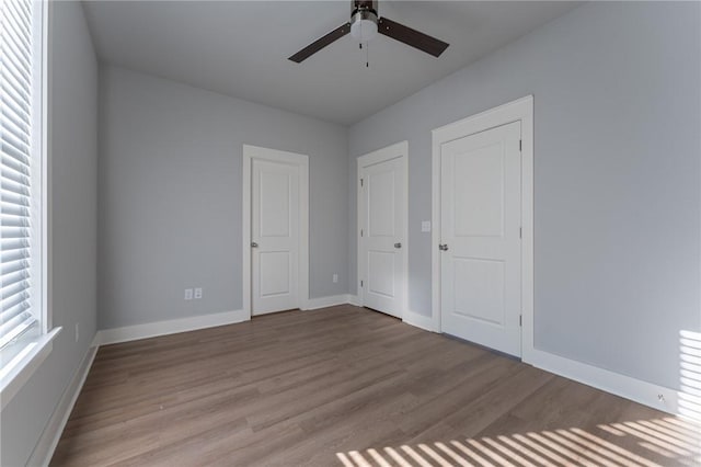 unfurnished bedroom featuring ceiling fan and light wood-type flooring