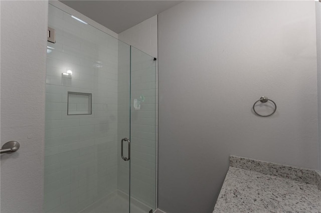 bathroom with a shower with shower door