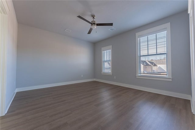 empty room with ceiling fan and dark wood-type flooring