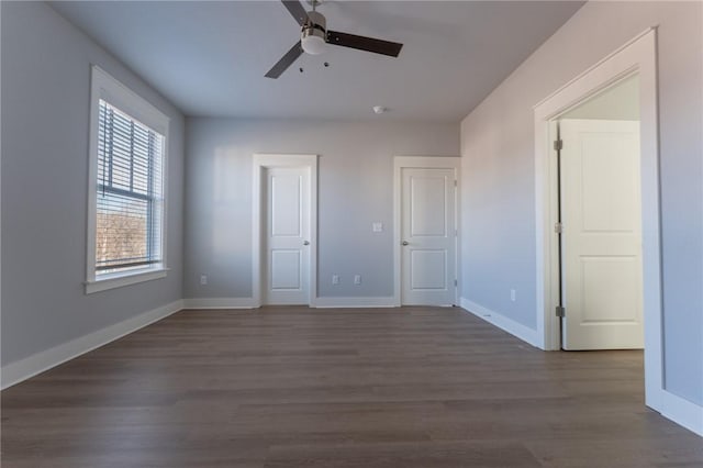 unfurnished bedroom featuring ceiling fan and dark hardwood / wood-style floors