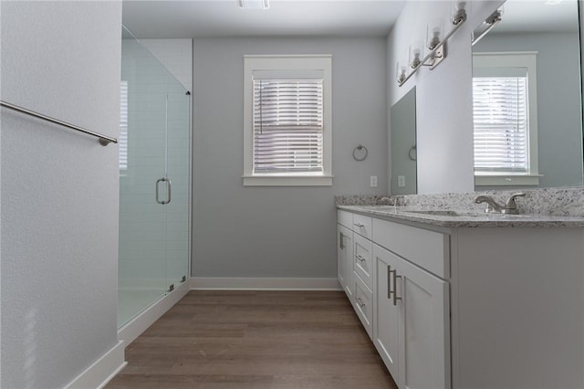 bathroom featuring vanity, hardwood / wood-style flooring, and walk in shower