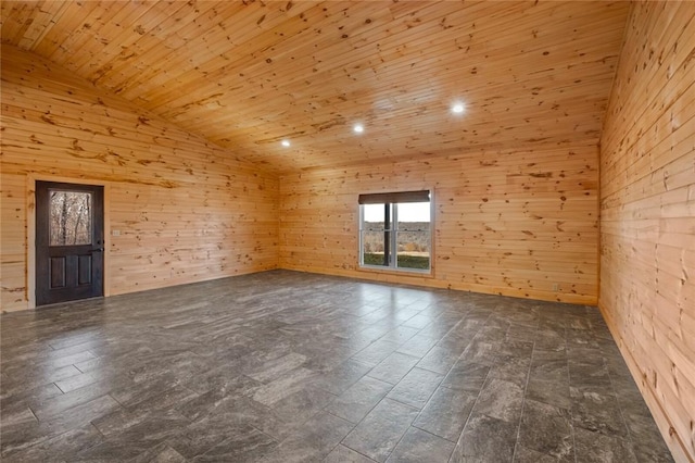 unfurnished room featuring vaulted ceiling, wooden walls, and wooden ceiling