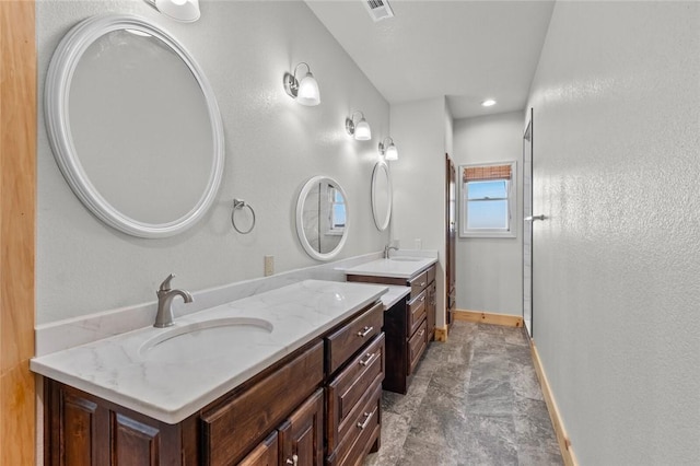 bathroom with a shower with door and vanity