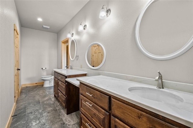 bathroom with toilet and vanity