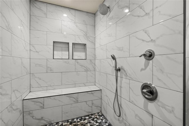 bathroom with tiled shower