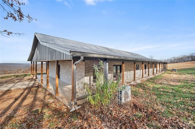 view of property exterior featuring a rural view and a patio