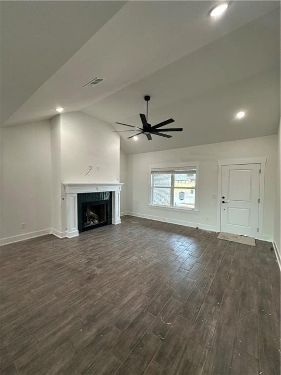 unfurnished living room with ceiling fan, dark wood-type flooring, and vaulted ceiling