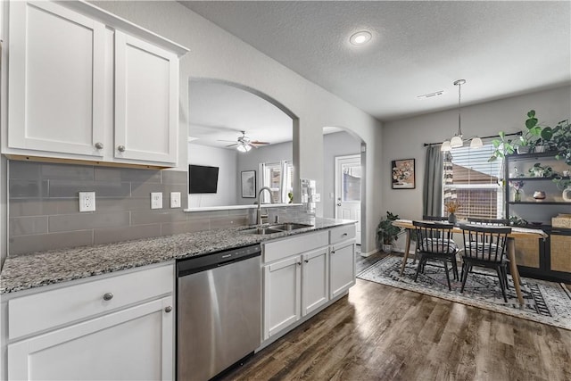 kitchen featuring dishwasher, sink, white cabinetry, and a textured ceiling