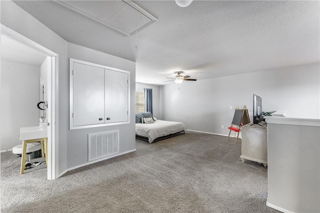 bedroom featuring a textured ceiling, carpet flooring, visible vents, baseboards, and attic access