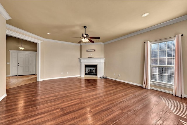 unfurnished living room with hardwood / wood-style flooring, crown molding, and ceiling fan