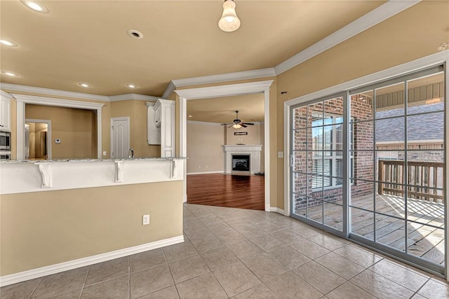 kitchen featuring light stone countertops, white cabinetry, and ornamental molding