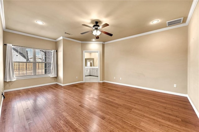 empty room with ceiling fan, wood-type flooring, and ornamental molding