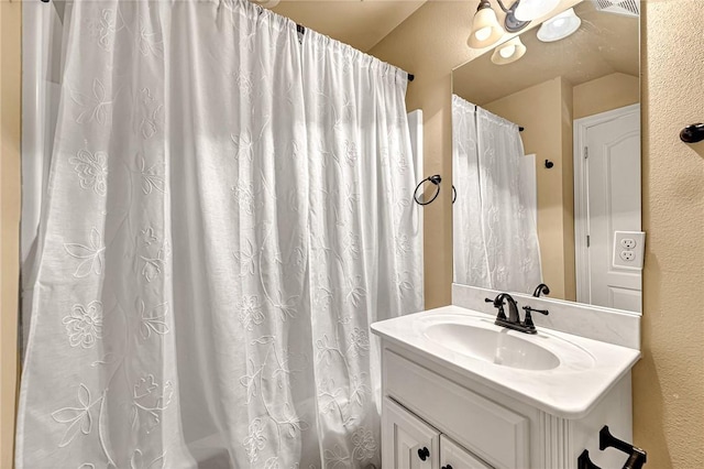 bathroom featuring vanity and a shower with curtain