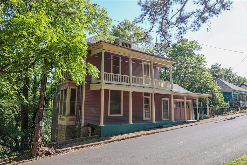 view of front of property featuring a balcony and covered porch